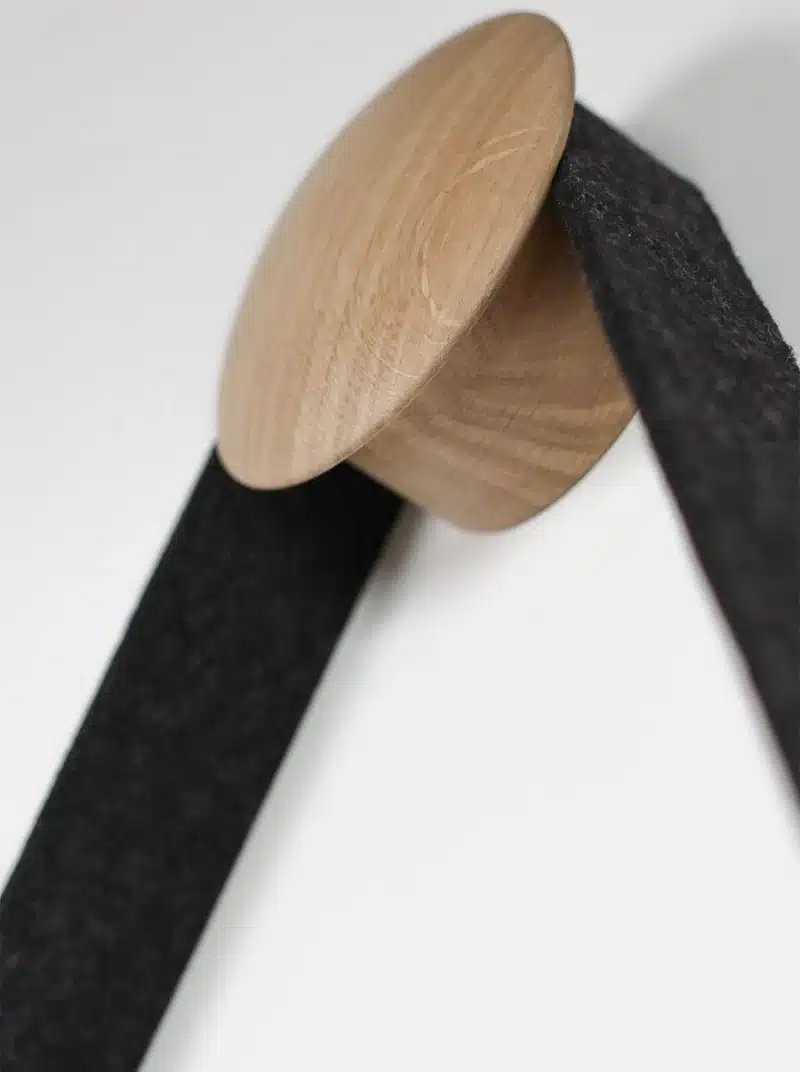 Wooden spool with black textile ribbon