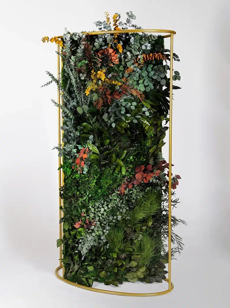 Vertical garden with mixed foliage in metal frame.